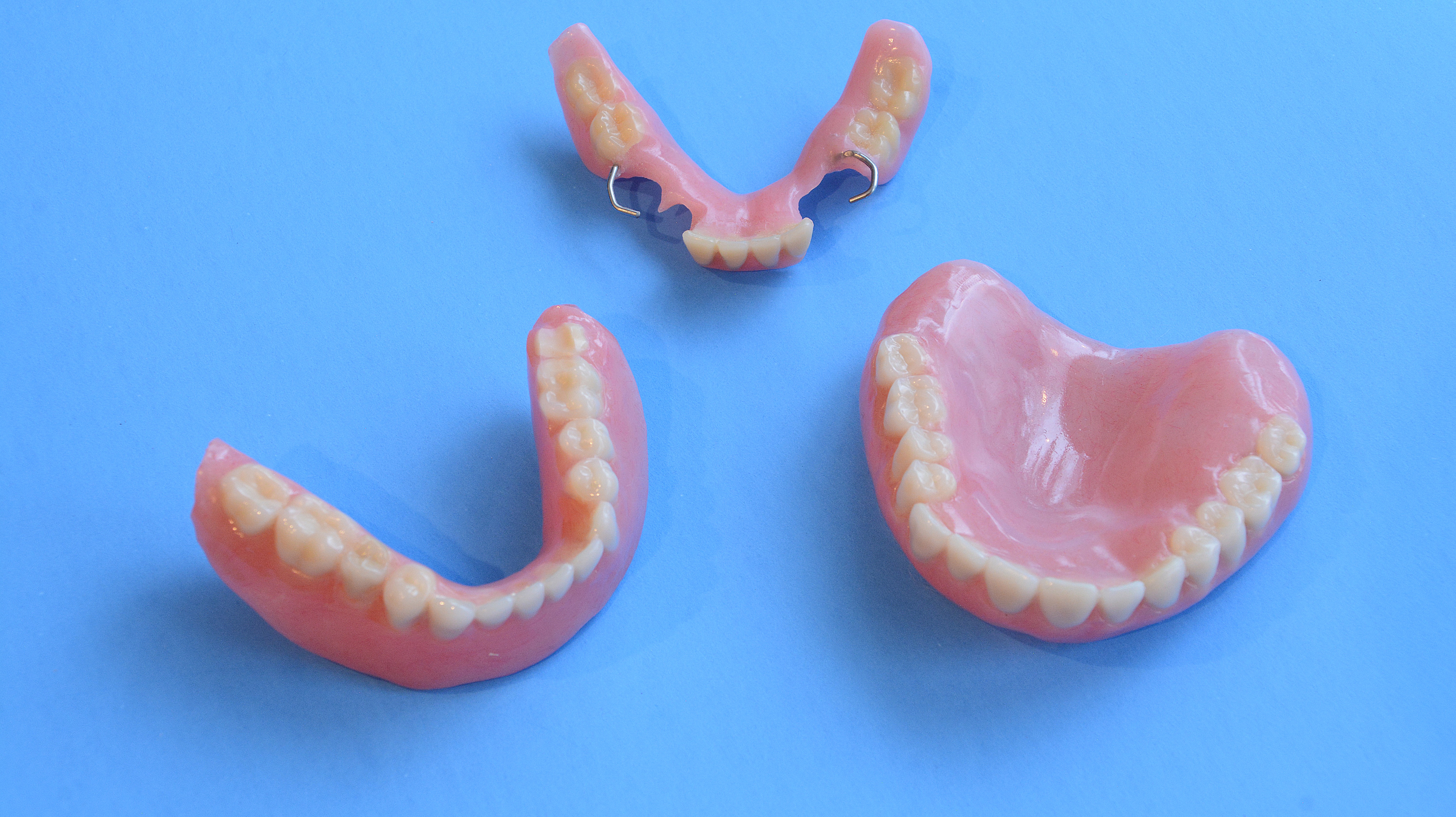 Repaired denture on blue background